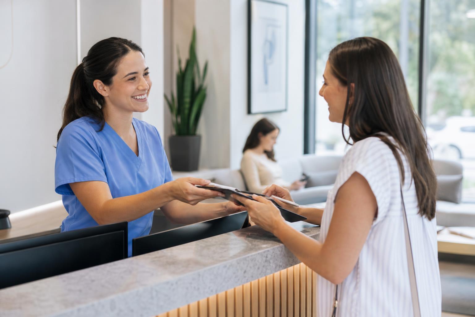 A dentist greeting a patient in a bright modern dental office